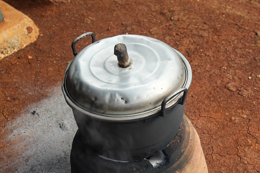 Traditional stove burner with a pan on top. traditional fire stove, using firewood