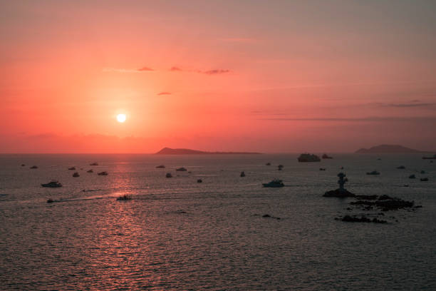 Sunset over the sea with beacon lighthouse