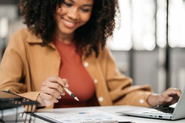 istock Female writes information businessman working on laptop computer writing business plan while sitting in office. 1956492186
