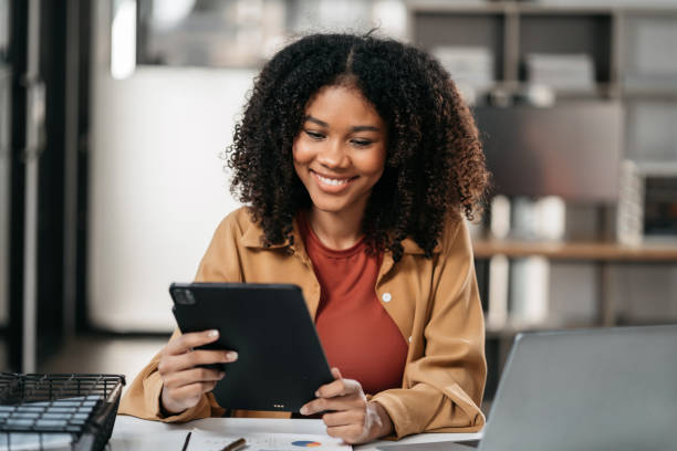 istock Female writes information businessman working on laptop computer writing business plan while sitting in office. 1956492390