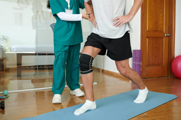 istock Man with Injured Leg Doing Lunges 1956522827