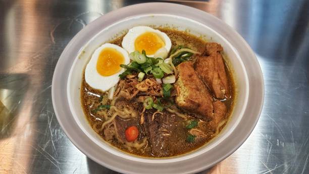 istock Asian kari noodle soup, served with egg, tofu and meat 1956536900