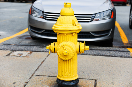 urban scene with a red fire hydrant standing tall on a sunlit street corner, symbolizing safety and preparedness