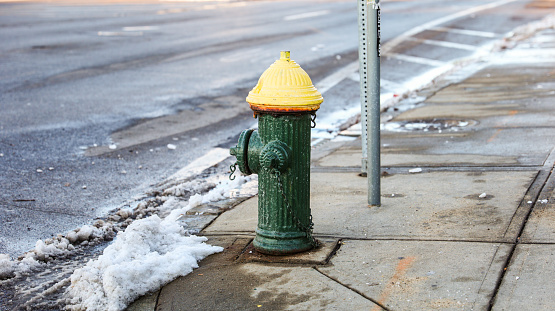 urban scene with a red fire hydrant standing tall on a sunlit street corner, symbolizing safety and preparedness
