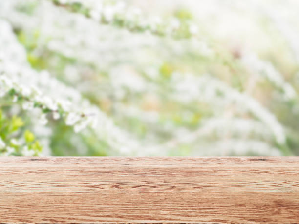 istock Wooden table background image with wood grain on natural green background 1956613162