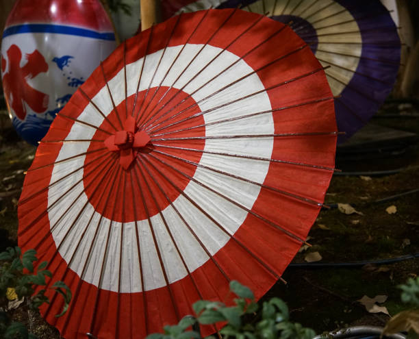 sun shining through a white hand fan, background with a blue and white summer sky