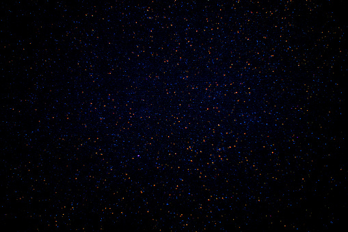 Red and blue sparks on a dark background.