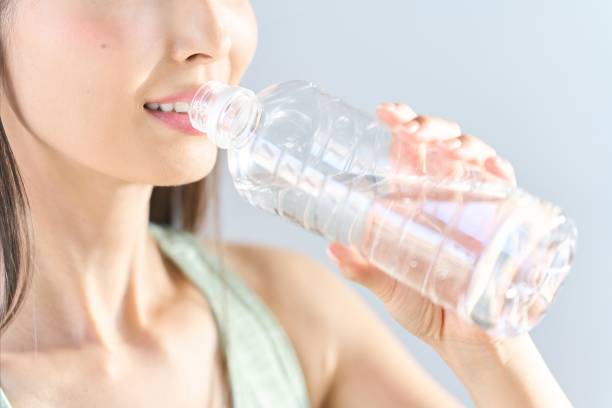 istock A woman drinking water from a plastic bottle 1956663899