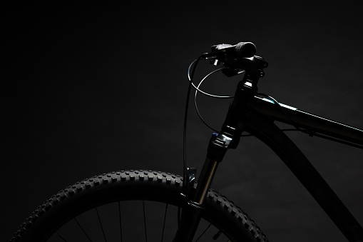 Black mountain bicycle on black background close up