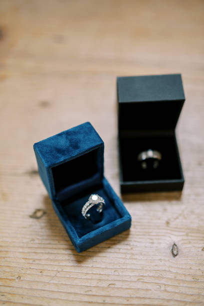 istock Wedding rings lie in boxes on a wooden table 1956711454