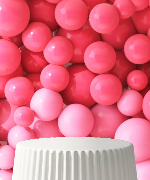 istock White round podium table, corrugated side with red and pink balloons in background 1956712982