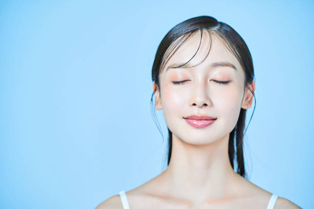 istock Young woman and light blue background 1956715088