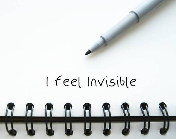 istock Pen wrote on notebook I FEEL INVISIBLE - feeling ignored or overlooked by the people around - no one recognize your existence - Experiencing social rejection contribute to invisibility feeling 1956728155