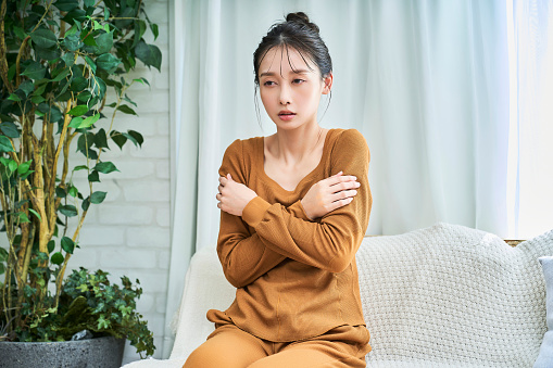 A young woman who is not feeling well wearing loungewear indoors