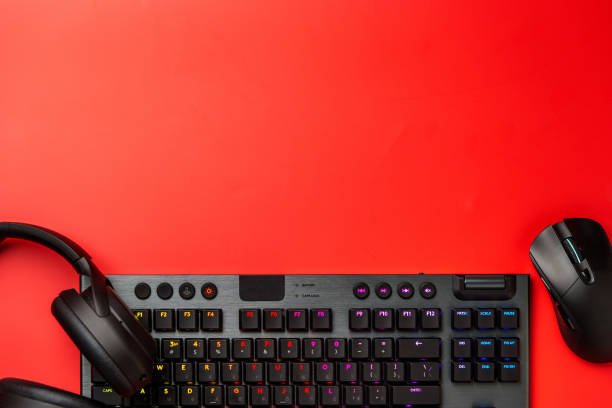 istock Computer keyboard and headphones on red background top view 1956750995