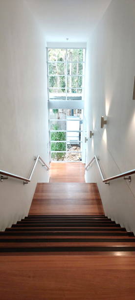 istock hallway down wooden stairs modern interior design with lighting from big window 1956759801