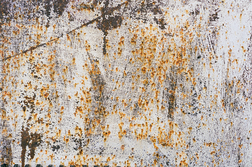 Old scratched and rusty painted metal surface, background texture. Texture of metal rusty wall brown white background. Cracked paint, rust surface.