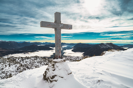 The cross on Mount Cancevo in the Lombardy pre-Alps of Italy in winter