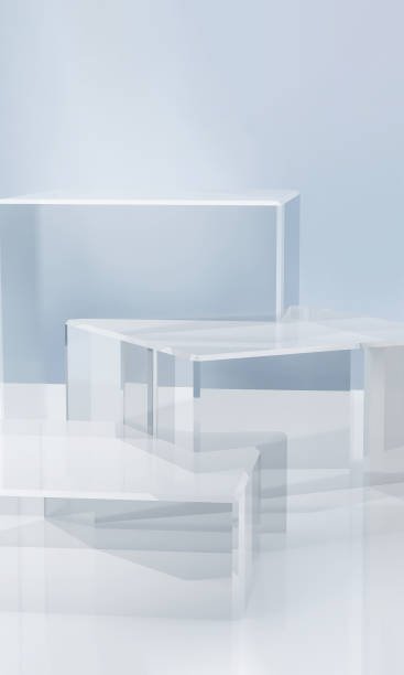 istock Three modern transparent cuboid podium, geometric pedestal on white counter, dappled light on blue wall 1956769099