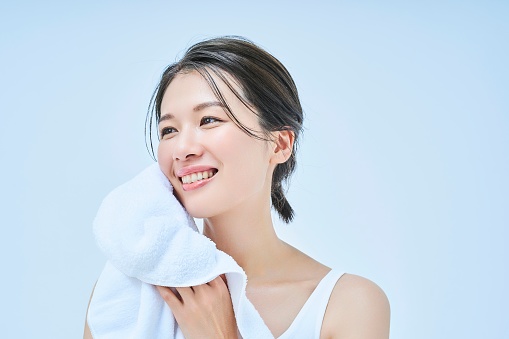woman wiping her face with a towel
