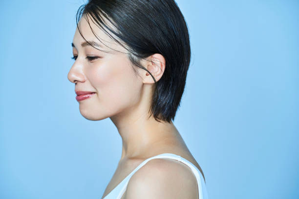 istock a woman standing in front of a plain background 1956790566