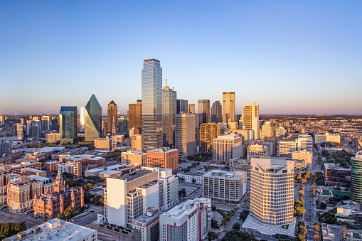 Aerial shot of downtown office buildings in Houston, Texas on a sunny afternoon.\n\nAuthorization was obtained from the FAA for this operation in restricted airspace.