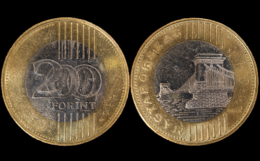 A close-up of a Hungarian 200 forint coin, the money of Hungary on a black background