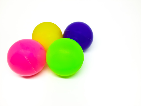 Cluster or cloud of colorful balls hover in the air. The balls are shiny and shows the rainbow colors.