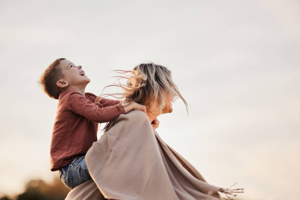 istock Carefree mother having fun with her son in nature. 1956802429
