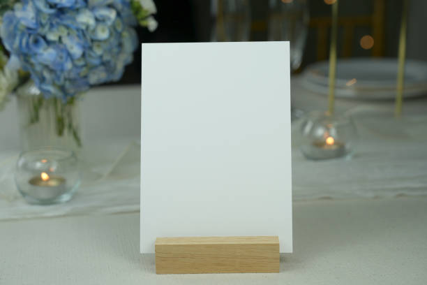 istock Mockup white blank space card, for greeting, table number, wedding invitation template on wedding table setting background. 1956802585