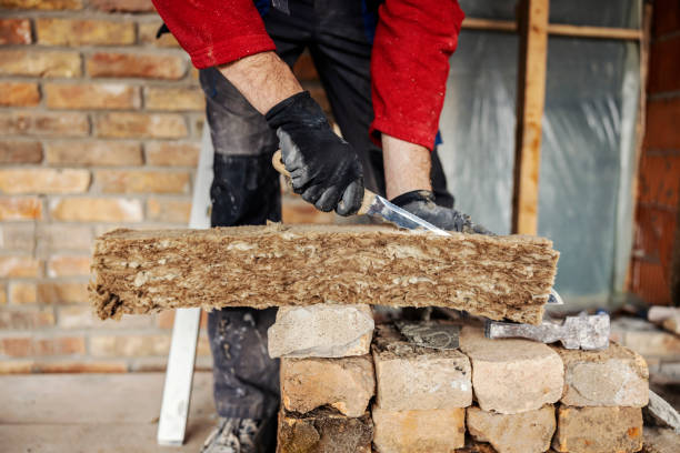 istock Close up of a housebuilder cutting insulation on a building area. 1956811637