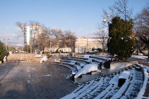 Nis, Serbia - 01/21/2024: City amphitheater covered in snow by the river Nisava on a sunny winter day in January.