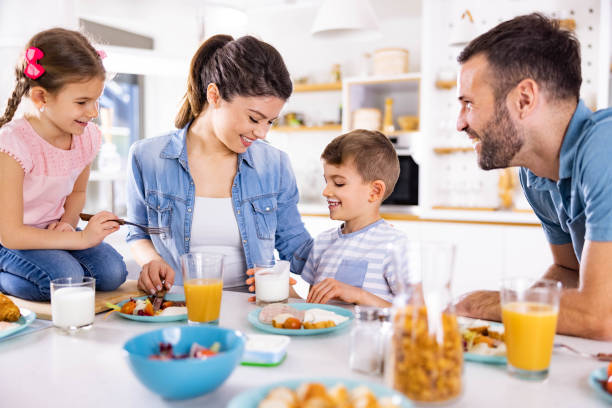 istock Happy family enjoying during breakfast in dining room. 1956834389