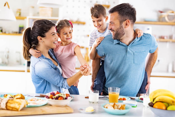 istock Happy family having fun during breakfast in dining room. 1956835433