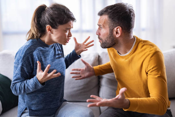 istock Mid adult couple arguing on sofa at home. 1956838580