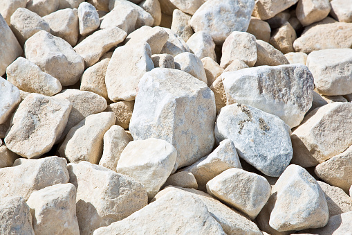 Expanse of white different sizes gravel in a construction site used in the construction industry and building activity for the construction of roadbeds
