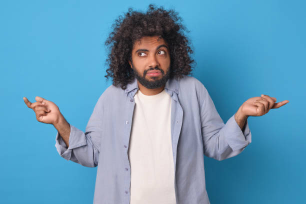 istock Young confused Arabian man throws up hands due to lack of qualifications 1956866266