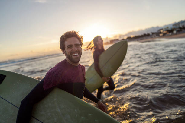 istock Couple with surfboards on surfing. 1956926930