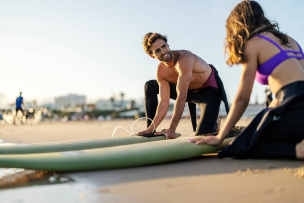 istock A surf instructor is explaining a girl basics of surfing. 1956929098