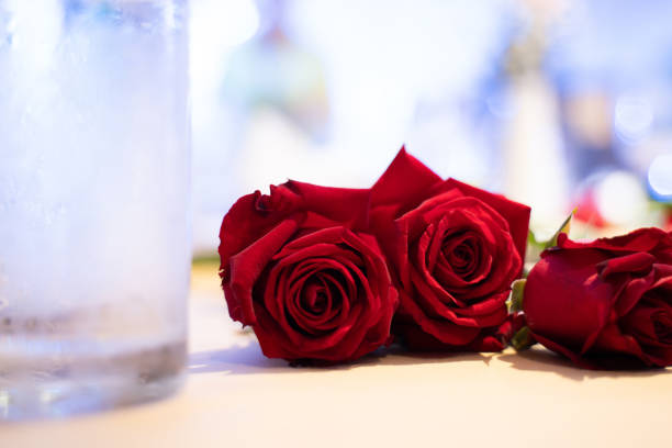 red roses on the table bokeh light background.