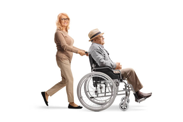 woman pushing an elderly gentleman in a wheelchair - physical injury men orthopedic equipment isolated on white imagens e fotografias de stock