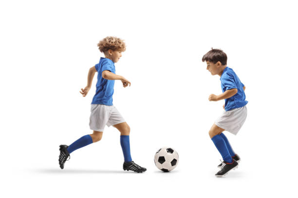 Two boys playing football isolated on white background