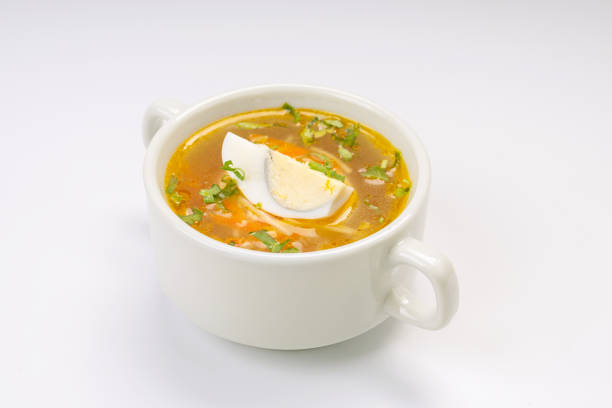 istock Business lunch. Soup. Chicken broth with egg in a white bowl on a white background 1956957004