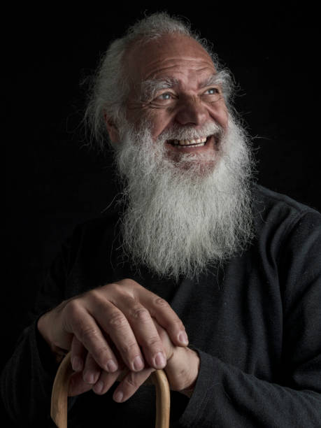 Close-up of a wise old man with a beard and long white hair in various positions
