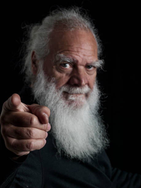 Close-up of a wise old man with a beard and long white hair in various positions