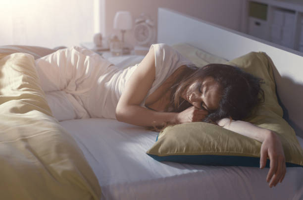 istock Woman sleeping in her bed 1956972419