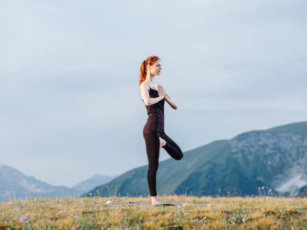 istock Athletic woman exercise gymnastics nature mountains 1956989495