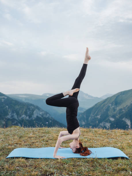 woman doing gymnastics exercise mountains nature yoga. High quality photo