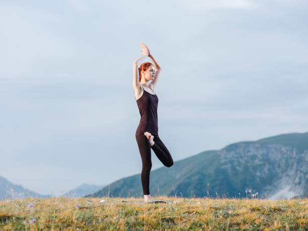 istock Athletic woman exercise gymnastics nature mountains 1956991686