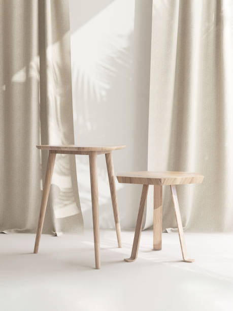 istock Two wooden geometric shape brown chairs with different height in sunlight, leaf shadow on beige curtain, wall 1956993360